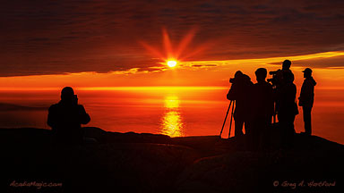 Silhouette of photographers on Cadillac Mountain during amazing sunrise