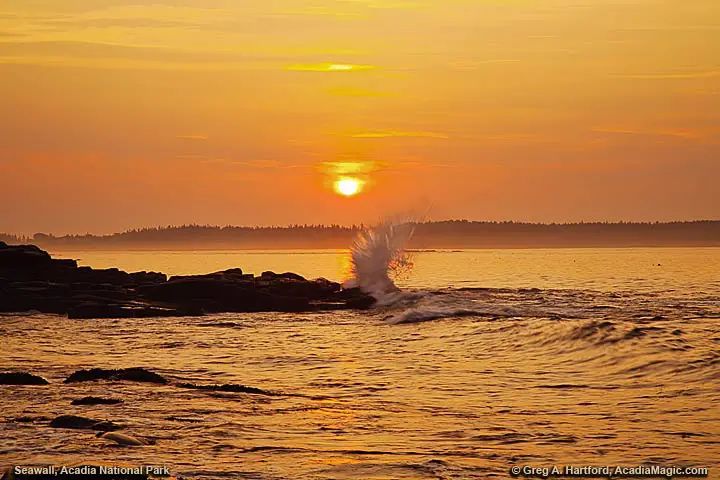 A wave crashes at Seawall in Acadia