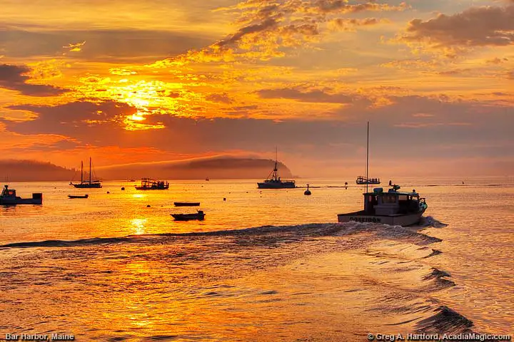 Lobster boat leaving harbor at sunrise