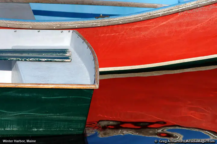 Interesting composition using red dinghy and reflections