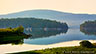 This shows Cadillac Mountain across the waters in Somes Sound as seen from Somesville, Maine.