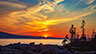This shows the gorgeous sunset over Mount Desert Island, Maine seen from Schoodic Point in Acadia National park on the mainland.
